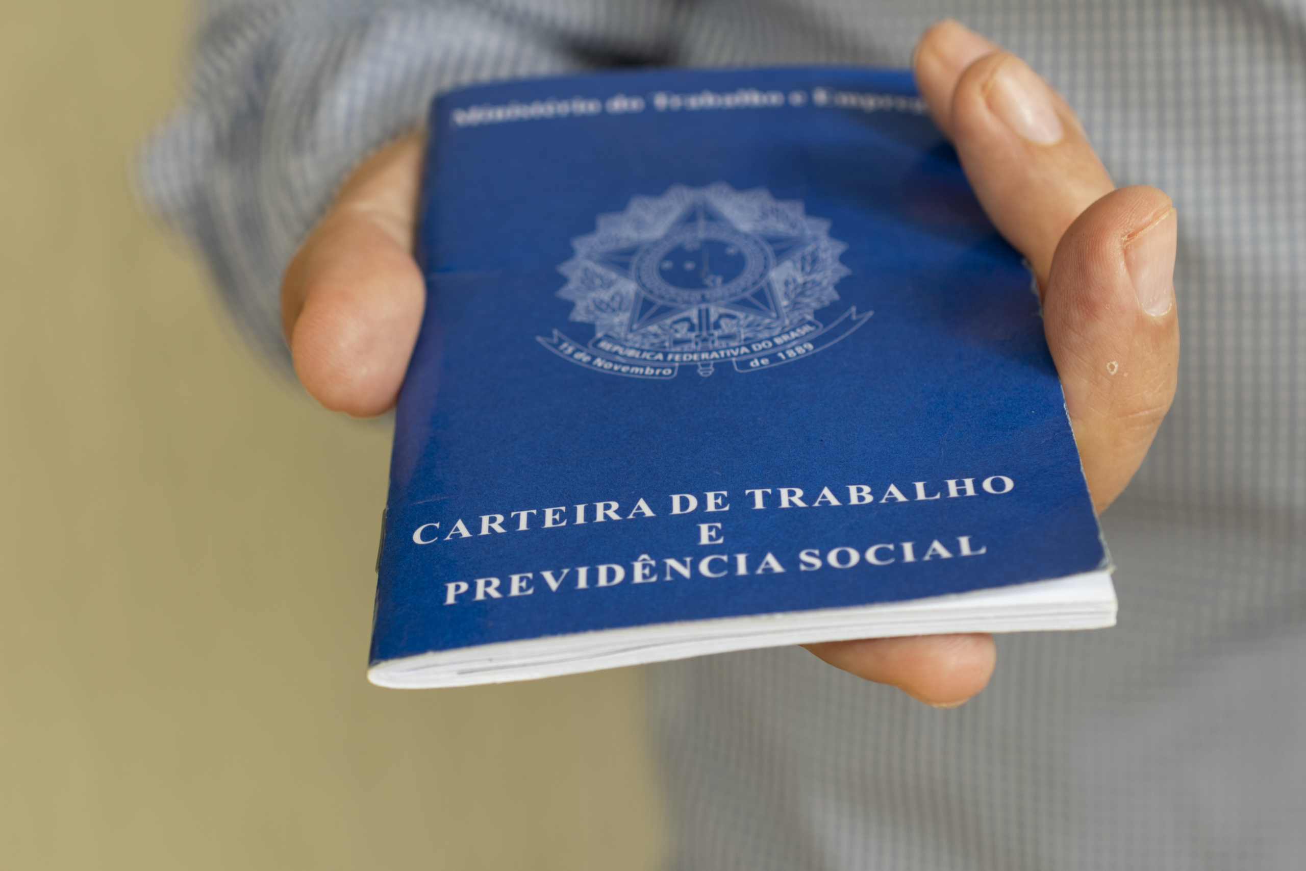 man with Brazilian work card. concept of employment and salary increase. Translation: Work and Social Security Card, in Portuguese